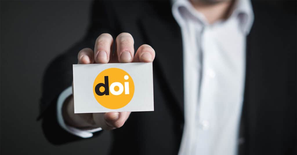 A man holding a card that says DOI